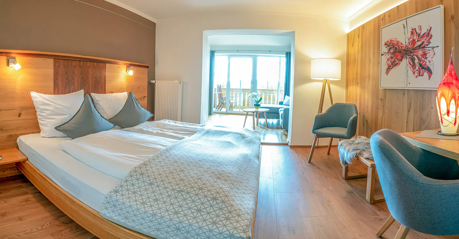 Lichtdurchflutetes JuniorSuite mit natürlichem Design und Ausblick ins Grüne – Ruhe und Erholung im Bayerischen Wald